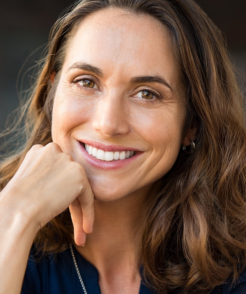 Woman with long brown hair smiling