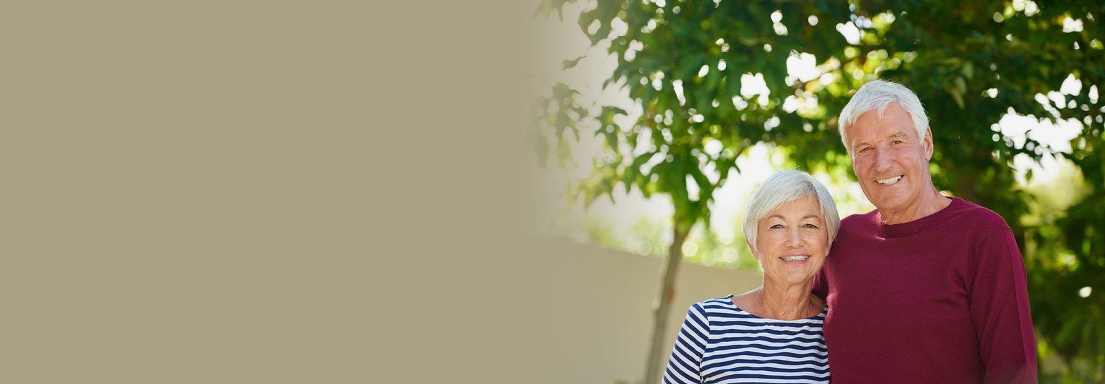 Older couple smiling, hugging