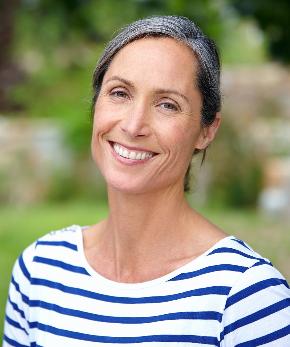 Woman smiling, wearing a striped shirt
