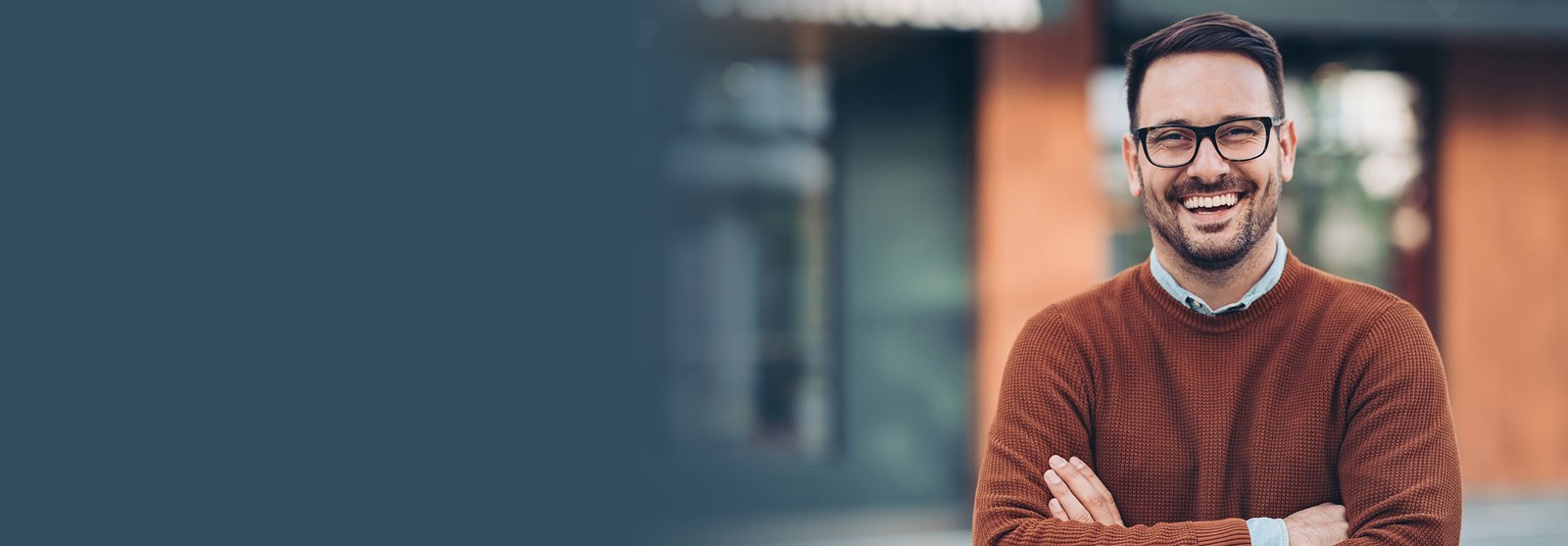 Man wearing glasses smiling outside