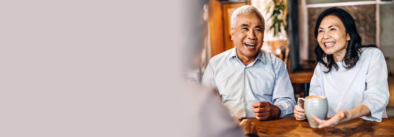 older couple sitting down drinking coffee